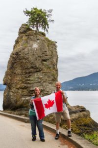 Aaron and me holding a Canadian flag in Stanley Park | LotsaSmiles Photography