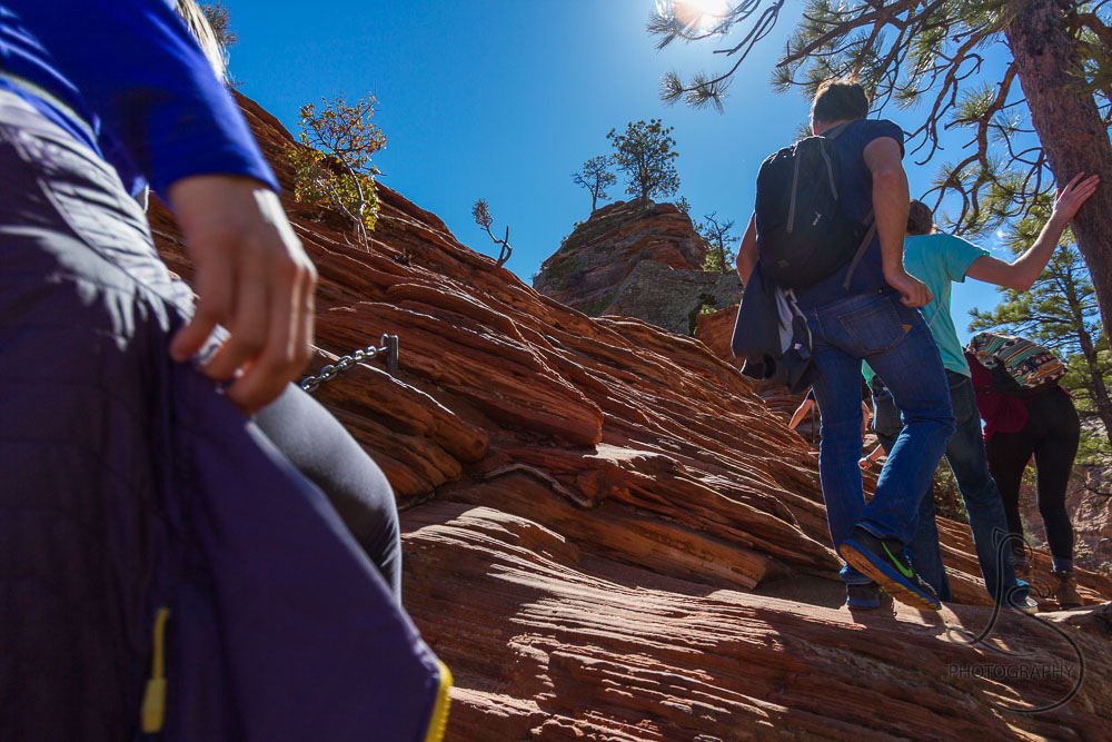 People ascending the Angels Landing trail, backlit by the sunny afternoon | LotsaSmiles Photography
